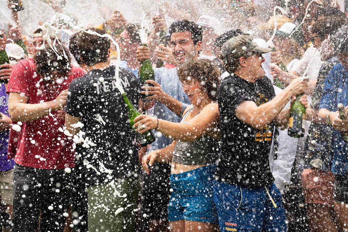 The Class of 2023 celebrates during the annual Champagne Showers at the Earle Flagpole in Worner Quad on 5/24/23. Photo by Lonnie Timmons III / Colorado College.